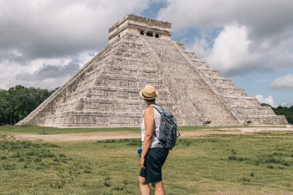 Woman traveler with hat and backpack in Chichen Itza Yucatan Mexico